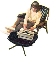 Lady typing on a tan Safari Typewriter